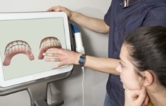 Dentist showing digital models of teeth to a patient