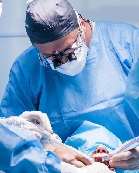 Oral surgeon operating on a patient