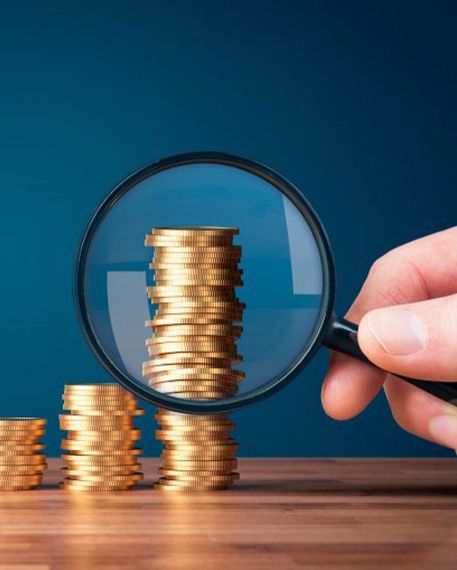 Stacks of coins examined with magnifying glass