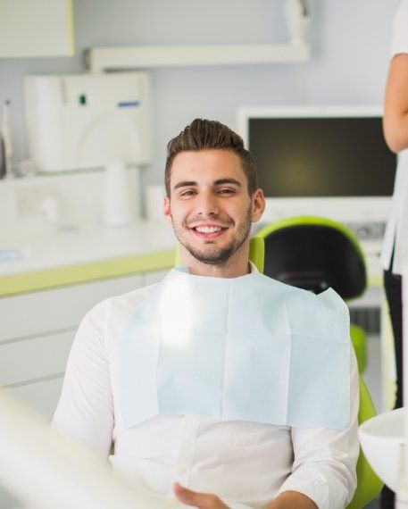 Smiling man sitting in dental chair