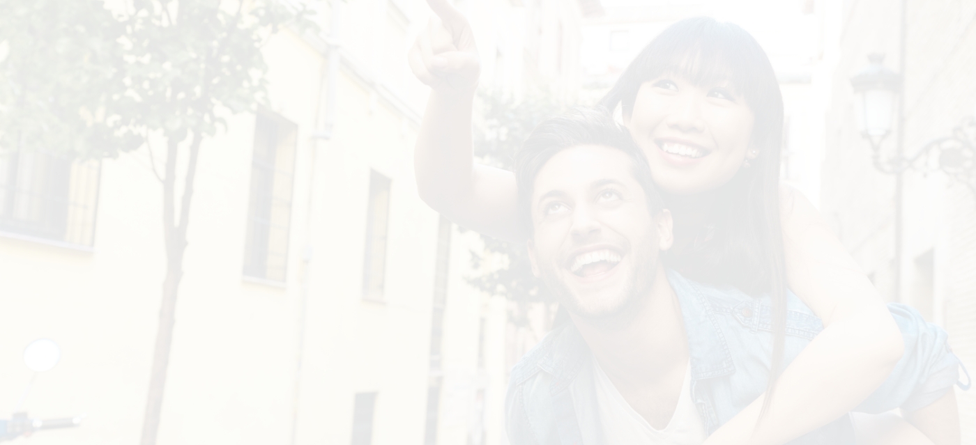 Woman holding man from behind and smiling after cosmetic dentistry