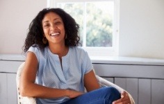 Smiling woman sitting on armchair