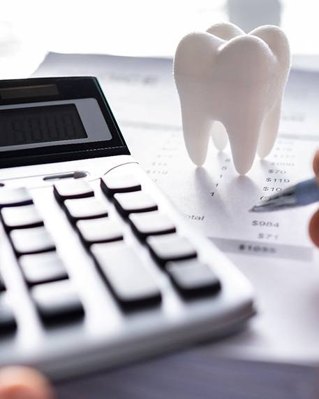 A patient calculating the cost of dental emergencies