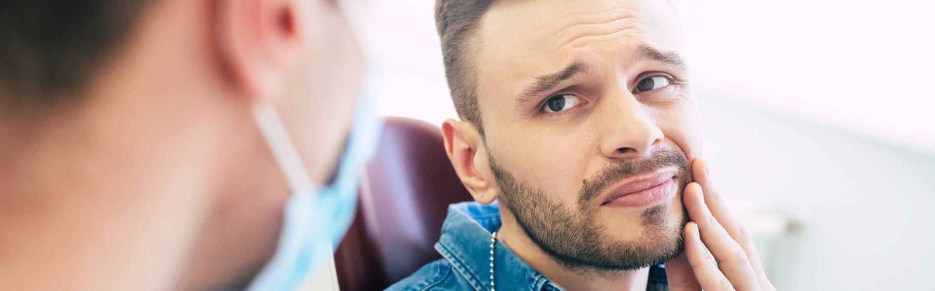 Patient with toothache looking at dentist