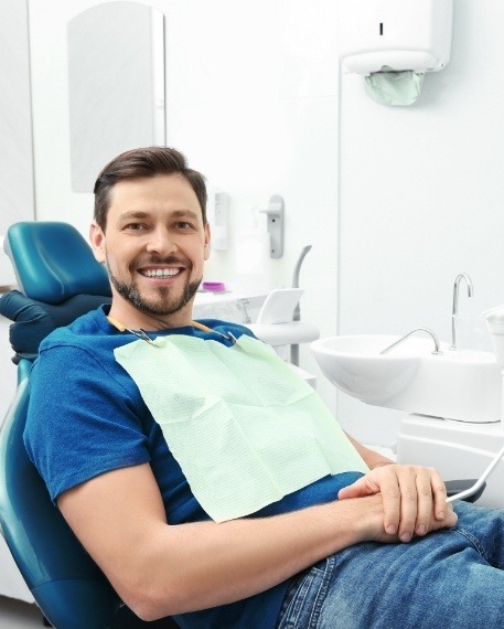 Smiling man sitting in dental chair