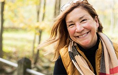 a smiling woman on a walk outside