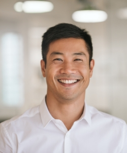 Man in white button-up shirt smiling