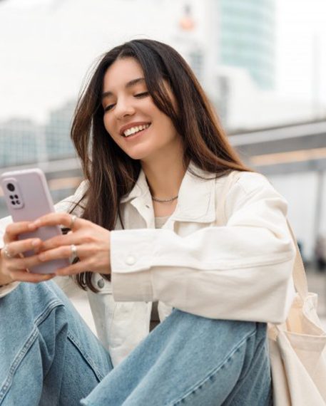 Lady smiles while reading something on phone