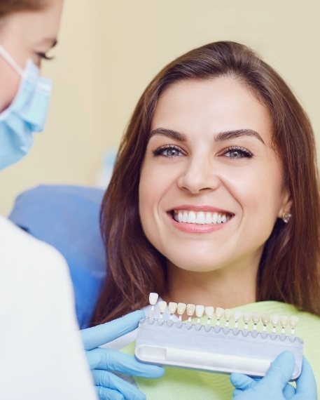 Woman in dental chair smiling while getting veneers in Parsippany Troy Hills