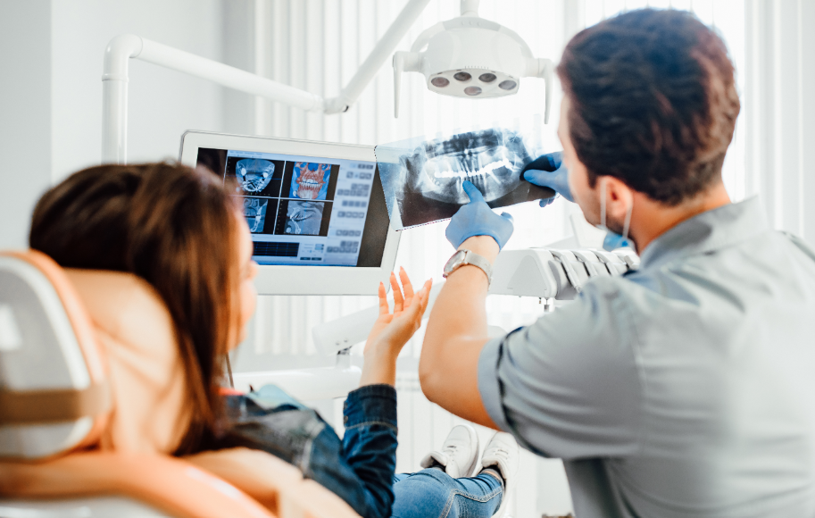 Dentist showing patient x-rays